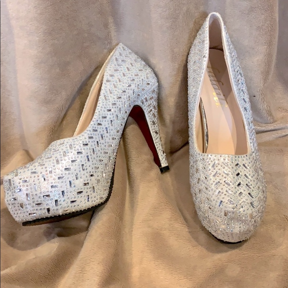 Sequined 4 inch high heeled shoes with red soles.